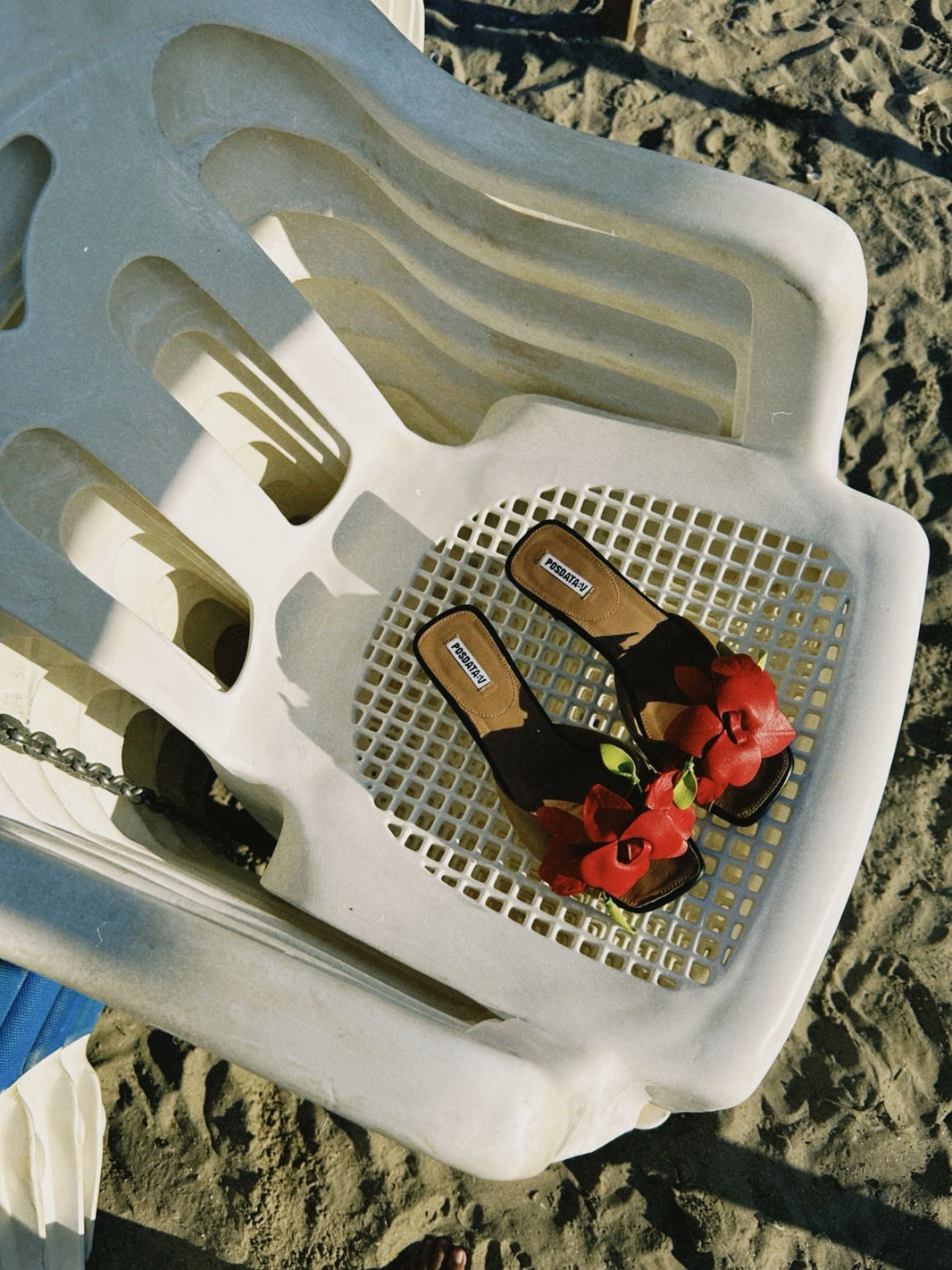 Pair of Beige Kitten Heels on top of chair at the beach
